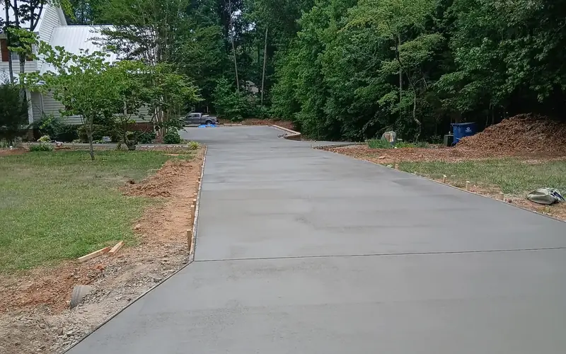 Broom-finish concrete driveway through wooded property, Yadkin County NC