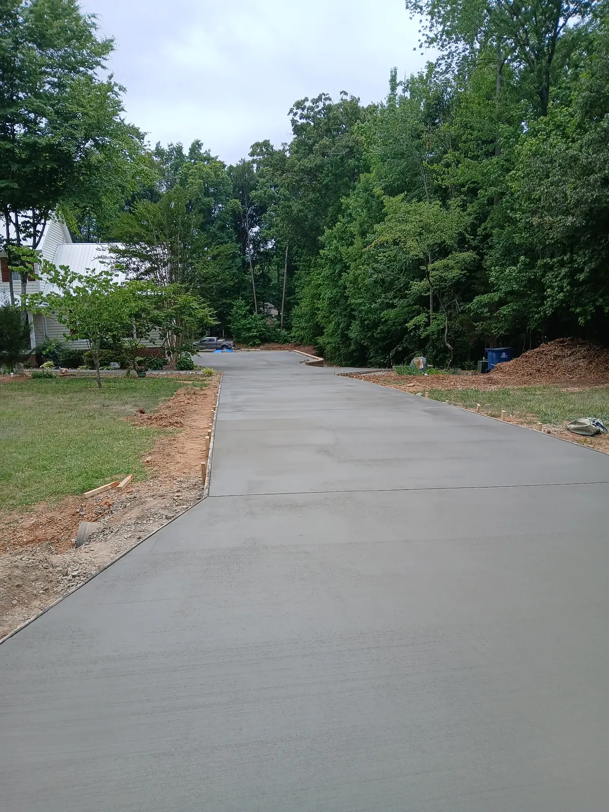 Broom-finish concrete driveway through wooded property, Yadkin County NC