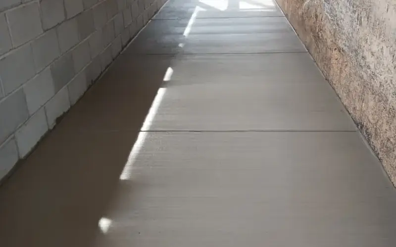 Concrete walkway poured between block walls
