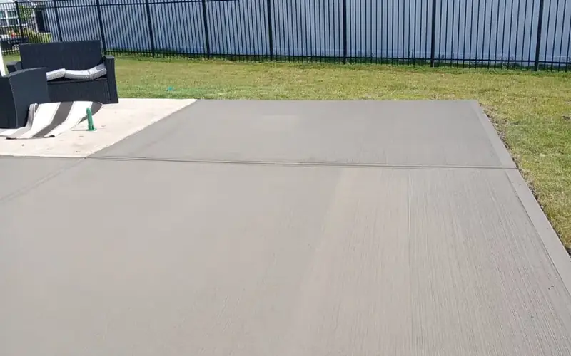 Backyard concrete patio with a broom finish